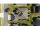 An aerial view shows the home has manicured grounds, a paved driveway, and a lush green lawn at 7283 Sw 94Th Ave, Ocala, FL 34481