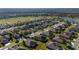 Birds-eye view of homes in a neighborhood with a golf course, highlighting the manicured lawns and tree-lined streets at 7283 Sw 94Th Ave, Ocala, FL 34481