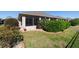 Backyard view with flower bushes, healthy green lawn, and views of the back of the home at 7283 Sw 94Th Ave, Ocala, FL 34481