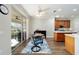 Bright dining area with wood floors, sliding glass doors to the lanai, and a view of the modern kitchen at 7283 Sw 94Th Ave, Ocala, FL 34481