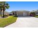 Charming one-story home with palm trees and well-manicured lawn with a two-car garage at 7283 Sw 94Th Ave, Ocala, FL 34481