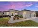 Charming one-story home with well-manicured landscaping and a two-car garage during a colorful sunset at 7283 Sw 94Th Ave, Ocala, FL 34481