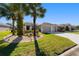 Beautiful one-story home with palm trees, lush green lawn and a spacious two-car garage at 7283 Sw 94Th Ave, Ocala, FL 34481