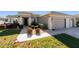 Charming one-story home with a well-maintained lawn, manicured shrubs, and a two-car garage at 7283 Sw 94Th Ave, Ocala, FL 34481