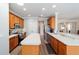 Spacious kitchen with stainless steel appliances, wood cabinets, a kitchen island, and backyard views at 7283 Sw 94Th Ave, Ocala, FL 34481