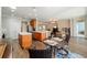 Open-concept kitchen with stainless steel appliances, island, and adjacent dining area and living room for seamless entertaining at 7283 Sw 94Th Ave, Ocala, FL 34481