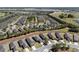 An aerial view shows a community of single-Gathering homes near a golf course and a serene lake at 7665 Sw 96Th Avenue Rd, Ocala, FL 34481