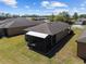 A bird's eye view of a backyard featuring a screened-in lanai and well-kept grass at 7665 Sw 96Th Avenue Rd, Ocala, FL 34481