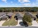 An aerial view of a well-maintained single-story home with a manicured lawn and a two-car garage at 7665 Sw 96Th Avenue Rd, Ocala, FL 34481