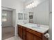 Bathroom with dual vanity and mirror with views to the bedroom at 7665 Sw 96Th Avenue Rd, Ocala, FL 34481