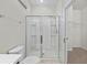 Bathroom shower enclosure with a white toilet at 7665 Sw 96Th Avenue Rd, Ocala, FL 34481