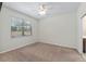 Bedroom featuring neutral carpet and a window offering outdoor views at 7665 Sw 96Th Avenue Rd, Ocala, FL 34481