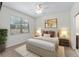 Cozy bedroom with a large window, neutral decor, carpet floors, and natural light at 7665 Sw 96Th Avenue Rd, Ocala, FL 34481