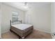 Bright bedroom with neutral walls, carpeted floors, a ceiling fan, and a double-door closet at 7665 Sw 96Th Avenue Rd, Ocala, FL 34481