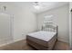 Cozy bedroom with neutral walls, carpeted floors, a ceiling fan, and natural light from the window at 7665 Sw 96Th Avenue Rd, Ocala, FL 34481