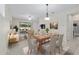 Open concept dining area with a wooden table, comfortable seating, and sliding glass doors to the backyard at 7665 Sw 96Th Avenue Rd, Ocala, FL 34481