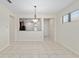 Light-filled dining room with tile flooring and view of the kitchen area at 7665 Sw 96Th Avenue Rd, Ocala, FL 34481