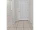 Bright entryway with tile flooring and a white front door that creates an inviting welcome at 7665 Sw 96Th Avenue Rd, Ocala, FL 34481