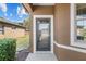 Inviting front entrance with a glass storm door, and a glimpse of the landscaped yard at 7665 Sw 96Th Avenue Rd, Ocala, FL 34481