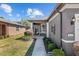 Inviting front entrance with a glass storm door, manicured landscaping, and neutral paint scheme at 7665 Sw 96Th Avenue Rd, Ocala, FL 34481