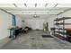 Bright garage with ample space, featuring shelving, a grill, and access to the home at 7665 Sw 96Th Avenue Rd, Ocala, FL 34481