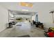 Spacious garage featuring white brick walls, an open door, and ample space for storage at 7665 Sw 96Th Avenue Rd, Ocala, FL 34481
