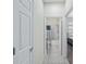 Hallway view leading to the bedroom and bathroom, showcasing the tile flooring and open layout at 7665 Sw 96Th Avenue Rd, Ocala, FL 34481