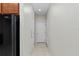 Hallway features neutral wall color, tile flooring, and white doors at 7665 Sw 96Th Avenue Rd, Ocala, FL 34481