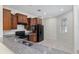 This kitchen is equipped with black appliances, granite countertops, and wood cabinetry at 7665 Sw 96Th Avenue Rd, Ocala, FL 34481
