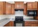The kitchen features black appliances, granite countertops, and wood cabinetry at 7665 Sw 96Th Avenue Rd, Ocala, FL 34481