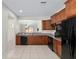 Traditional kitchen featuring wood cabinets, granite countertops, and black appliances at 7665 Sw 96Th Avenue Rd, Ocala, FL 34481