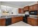 The kitchen has black appliances, granite countertops, and wood cabinetry at 7665 Sw 96Th Avenue Rd, Ocala, FL 34481