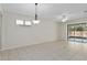 Open concept living area with tile floors, slider access to the lanai, and lots of light at 7665 Sw 96Th Avenue Rd, Ocala, FL 34481