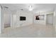 Bright living room features tile flooring, neutral paint, and an open floor plan to the kitchen at 7665 Sw 96Th Avenue Rd, Ocala, FL 34481