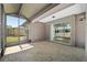 Spacious screened patio with tile flooring and sliding glass doors to the interior of the house at 7665 Sw 96Th Avenue Rd, Ocala, FL 34481
