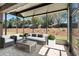 Screened-in patio with stylish outdoor furniture, perfect for relaxing and enjoying the backyard view at 7665 Sw 96Th Avenue Rd, Ocala, FL 34481