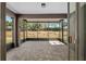 Enclosed patio featuring a paved floor, screen windows, and a view of the well-maintained backyard at 7665 Sw 96Th Avenue Rd, Ocala, FL 34481