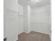 Spacious walk-in closet featuring carpeted floors and multiple wire shelving units for optimal storage at 7665 Sw 96Th Avenue Rd, Ocala, FL 34481