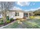 Home exterior features manicured landscaping, lush green lawn, and screened in lanai at 8344 Sw 79Th Cir, Ocala, FL 34476