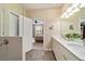 Bathroom with double vanity, modern lighting, and a doorway leading to the bedroom at 8344 Sw 79Th Cir, Ocala, FL 34476