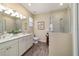 Modern bathroom with double vanity, tiled floors, and a glass-enclosed walk-in shower for spa-like feel at 8344 Sw 79Th Cir, Ocala, FL 34476