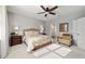 Comfortable bedroom featuring a ceiling fan, ensuite bath, and ample natural light at 8344 Sw 79Th Cir, Ocala, FL 34476