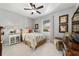 Comfortable bedroom featuring a ceiling fan, neutral walls, and tropical-themed decor creating a relaxing atmosphere at 8344 Sw 79Th Cir, Ocala, FL 34476