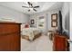 Cozy bedroom featuring a ceiling fan, window, and dresser at 8344 Sw 79Th Cir, Ocala, FL 34476