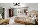Bright bedroom featuring a large window, dark ceiling fan, and a spacious closet at 8344 Sw 79Th Cir, Ocala, FL 34476