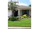 Charming home exterior with a well-manicured lawn, a flowering tree, and decorative landscaping at 8344 Sw 79Th Cir, Ocala, FL 34476