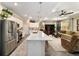Lovely kitchen with stainless steel appliances, quartz countertops, and a breakfast bar open to the living area at 8344 Sw 79Th Cir, Ocala, FL 34476