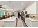 Spacious kitchen with stainless steel appliances, quartz countertops, pendant lights, and convenient breakfast bar at 8344 Sw 79Th Cir, Ocala, FL 34476