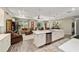 Open-concept kitchen with island connects seamlessly to the living area, creating a spacious and inviting atmosphere at 8344 Sw 79Th Cir, Ocala, FL 34476