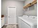 Bright laundry room with washer, dryer, and built-in shelving for storage at 8344 Sw 79Th Cir, Ocala, FL 34476